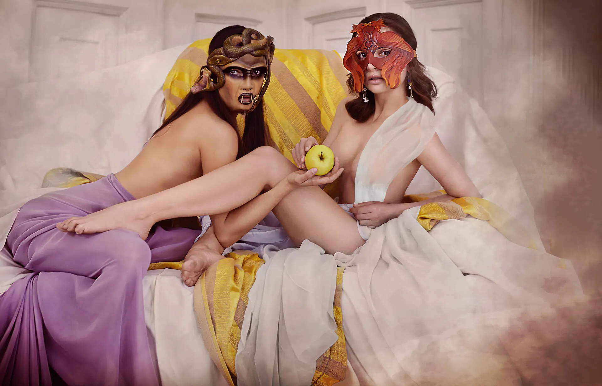Two performers in mythological masks and draped costumes